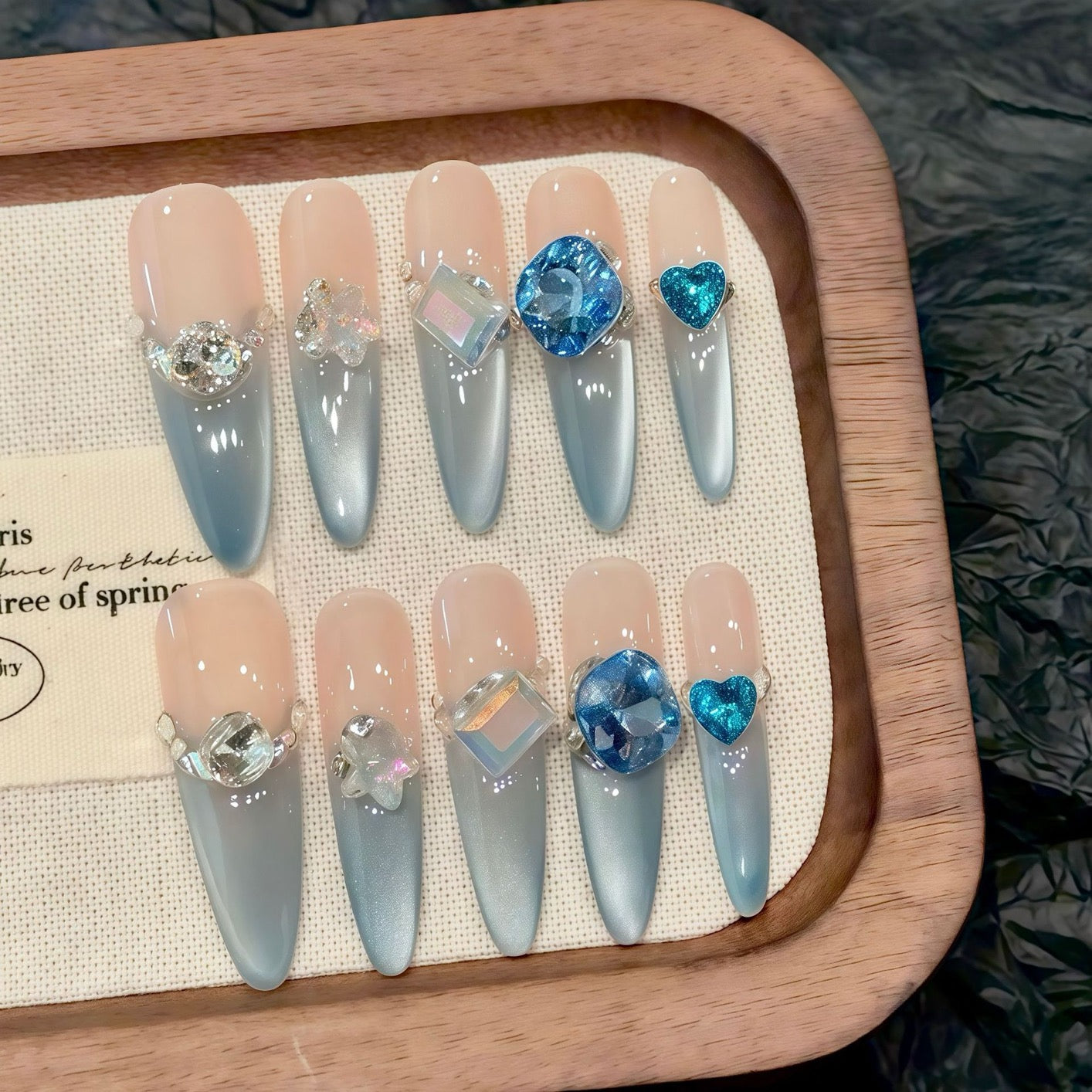 Aquamarine French gradient side-light cat's eye small diamond sparkly blue Danube light therapy wearing nail polish