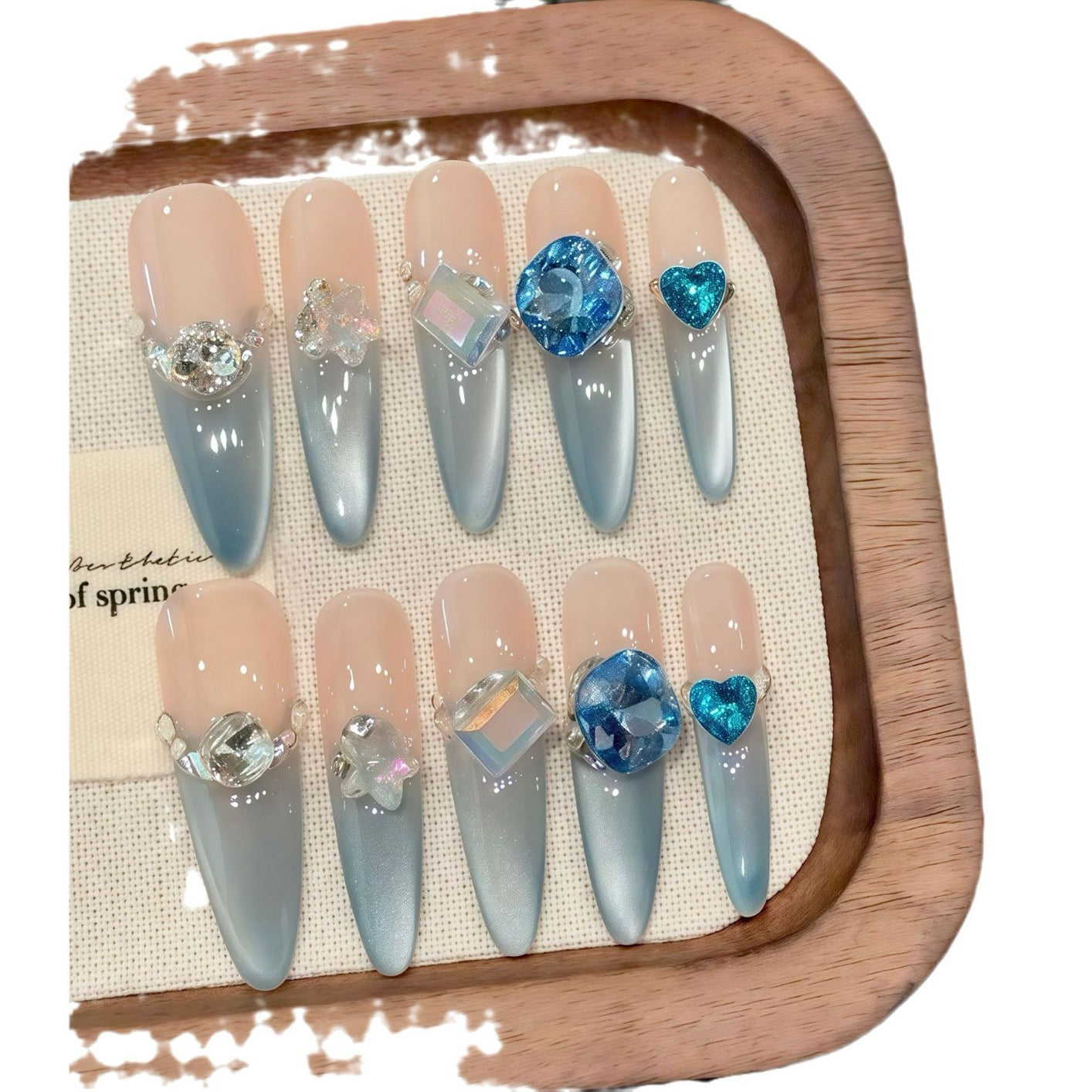 Aquamarine French gradient side-light cat's eye small diamond sparkly blue Danube light therapy wearing nail polish