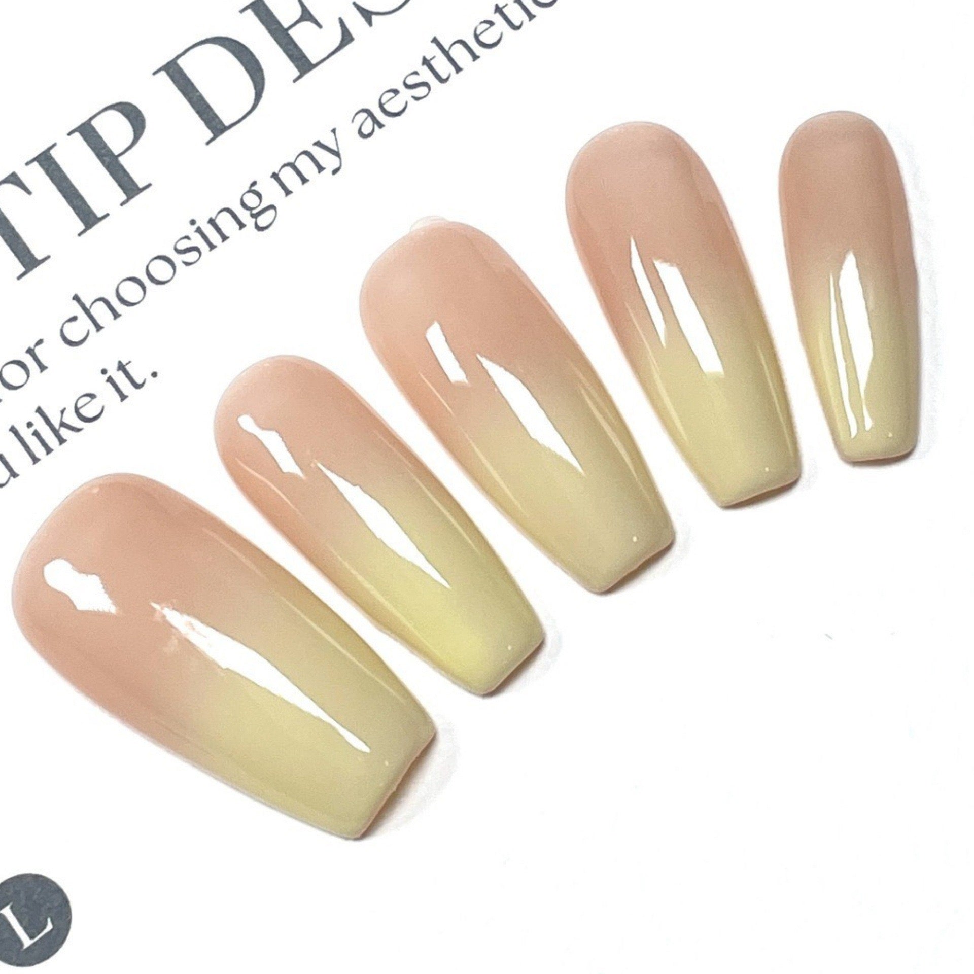 High-quality handmade eco-friendly nail art with faux nails for autumn and winter. Soft peach-yellow gradient blush with a cozy atmosphere.