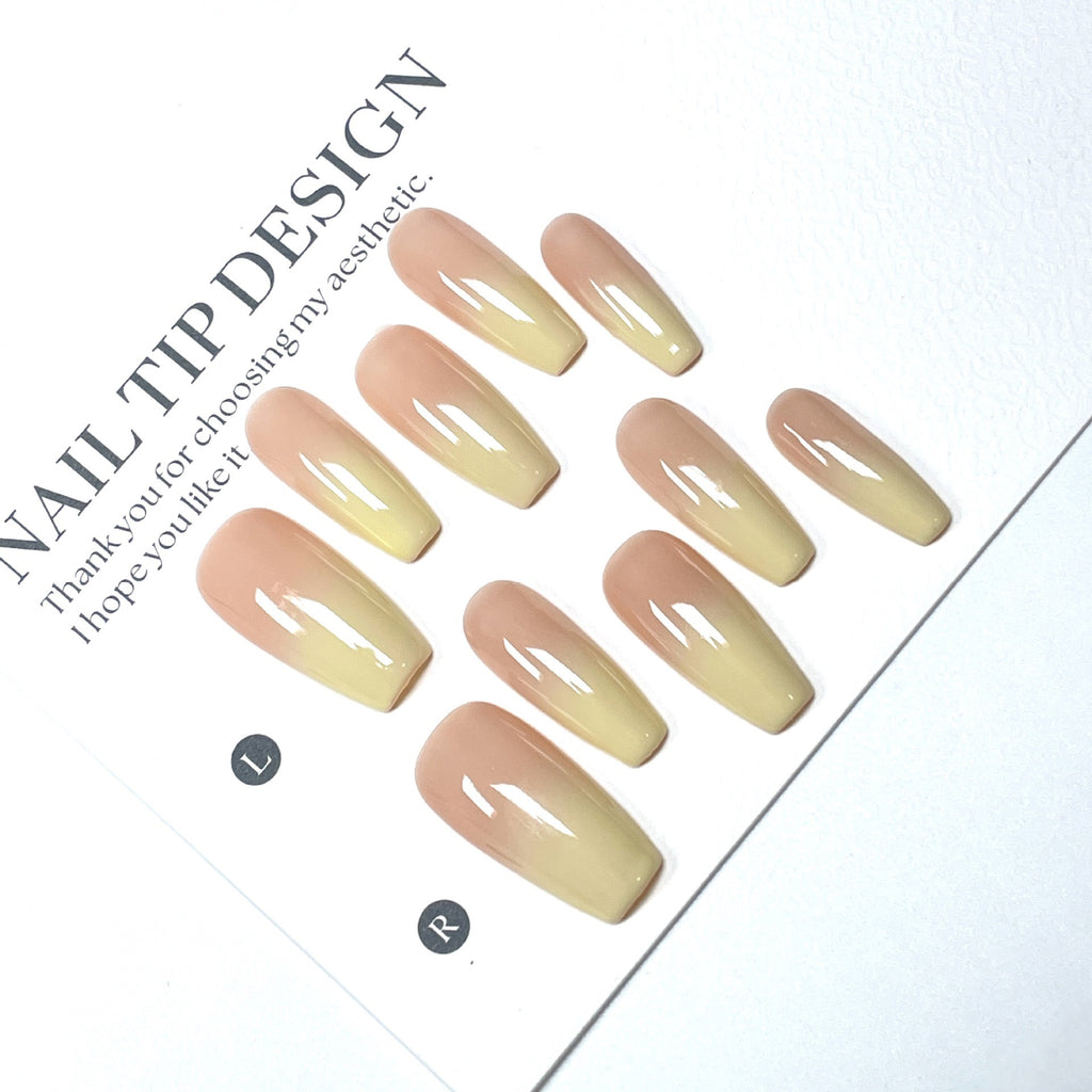High-quality handmade eco-friendly nail art with faux nails for autumn and winter. Soft peach-yellow gradient blush with a cozy atmosphere.