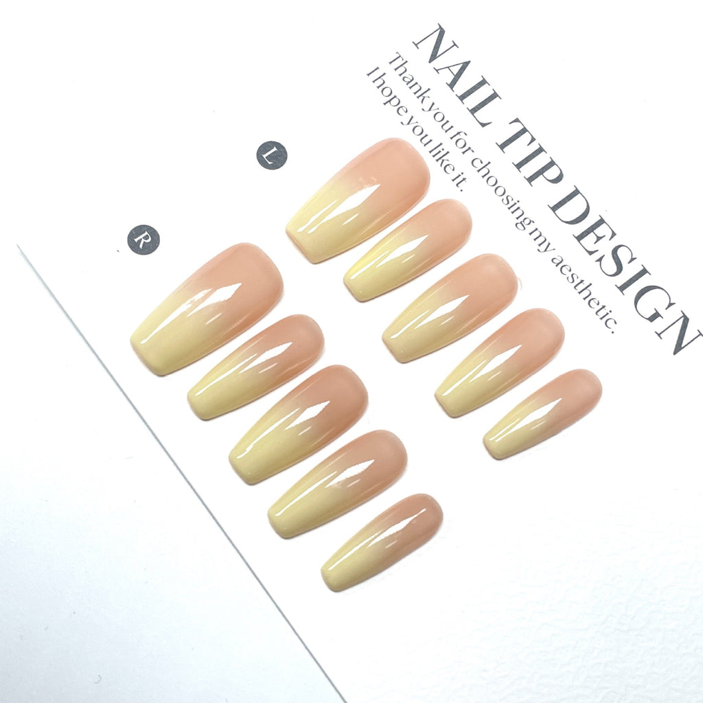 High-quality handmade eco-friendly nail art with faux nails for autumn and winter. Soft peach-yellow gradient blush with a cozy atmosphere.