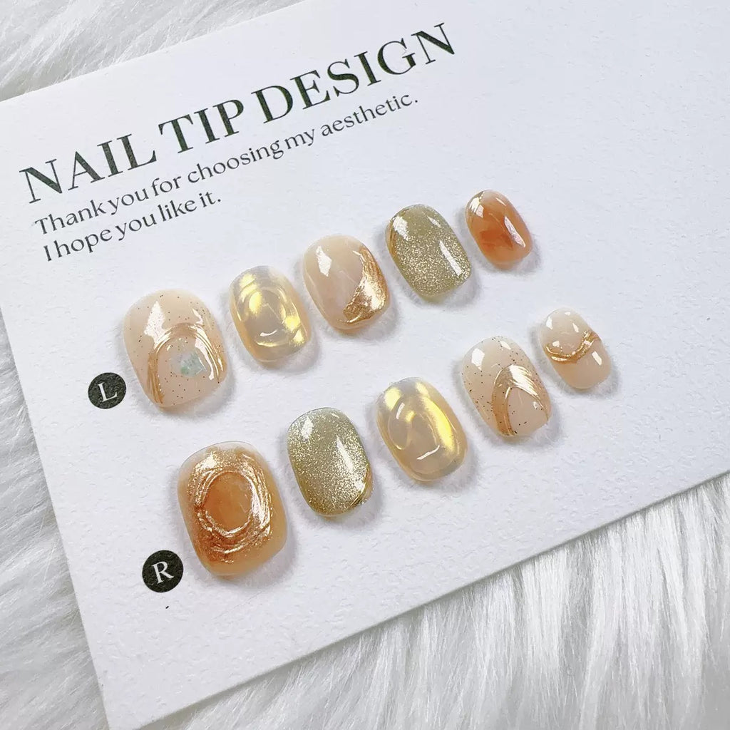 Handmade nail art with gold cat's eye French manicure, gold foil and mother-of-pearl inlaid with engraved patterns.