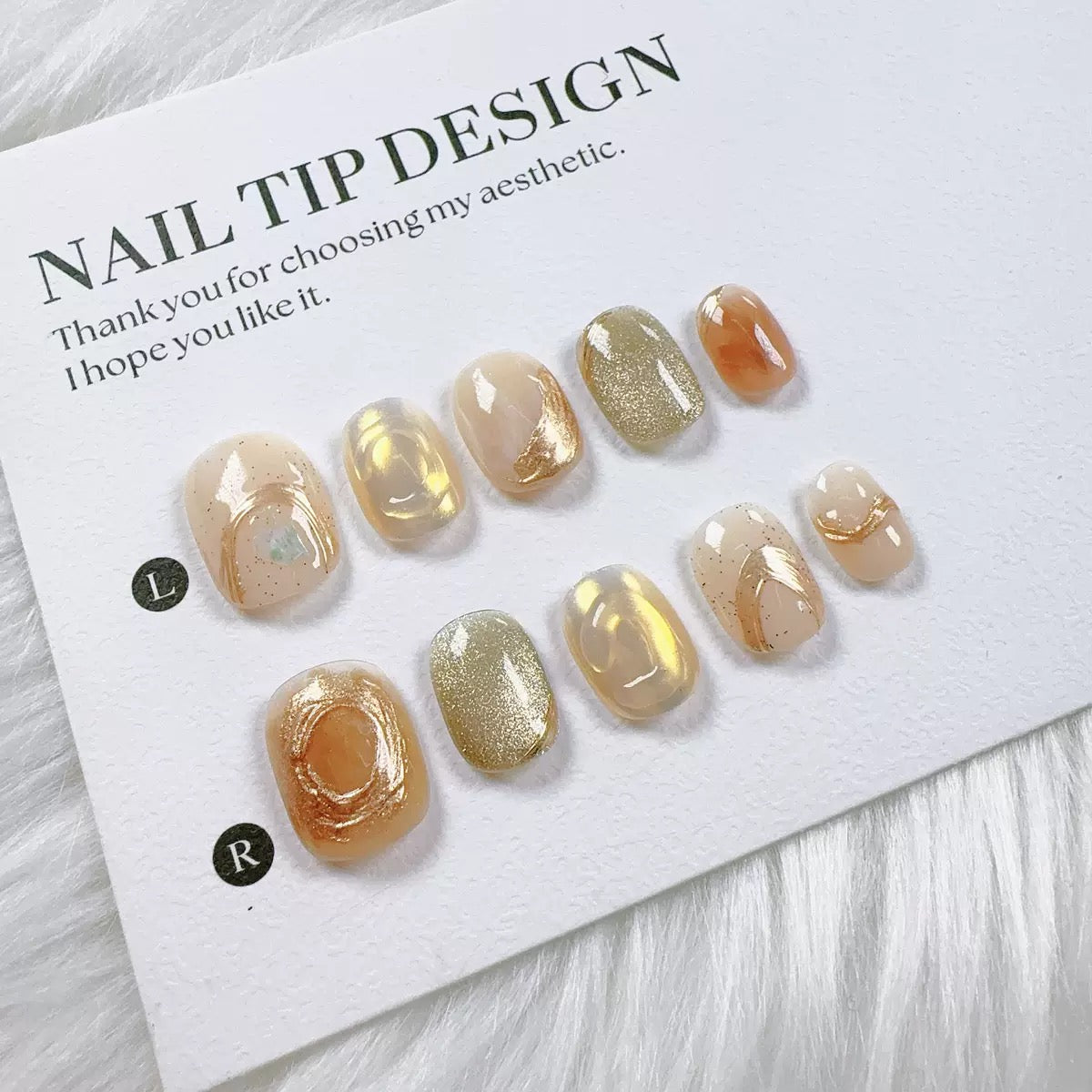 Handmade nail art with gold cat's eye French manicure, gold foil and mother-of-pearl inlaid with engraved patterns.