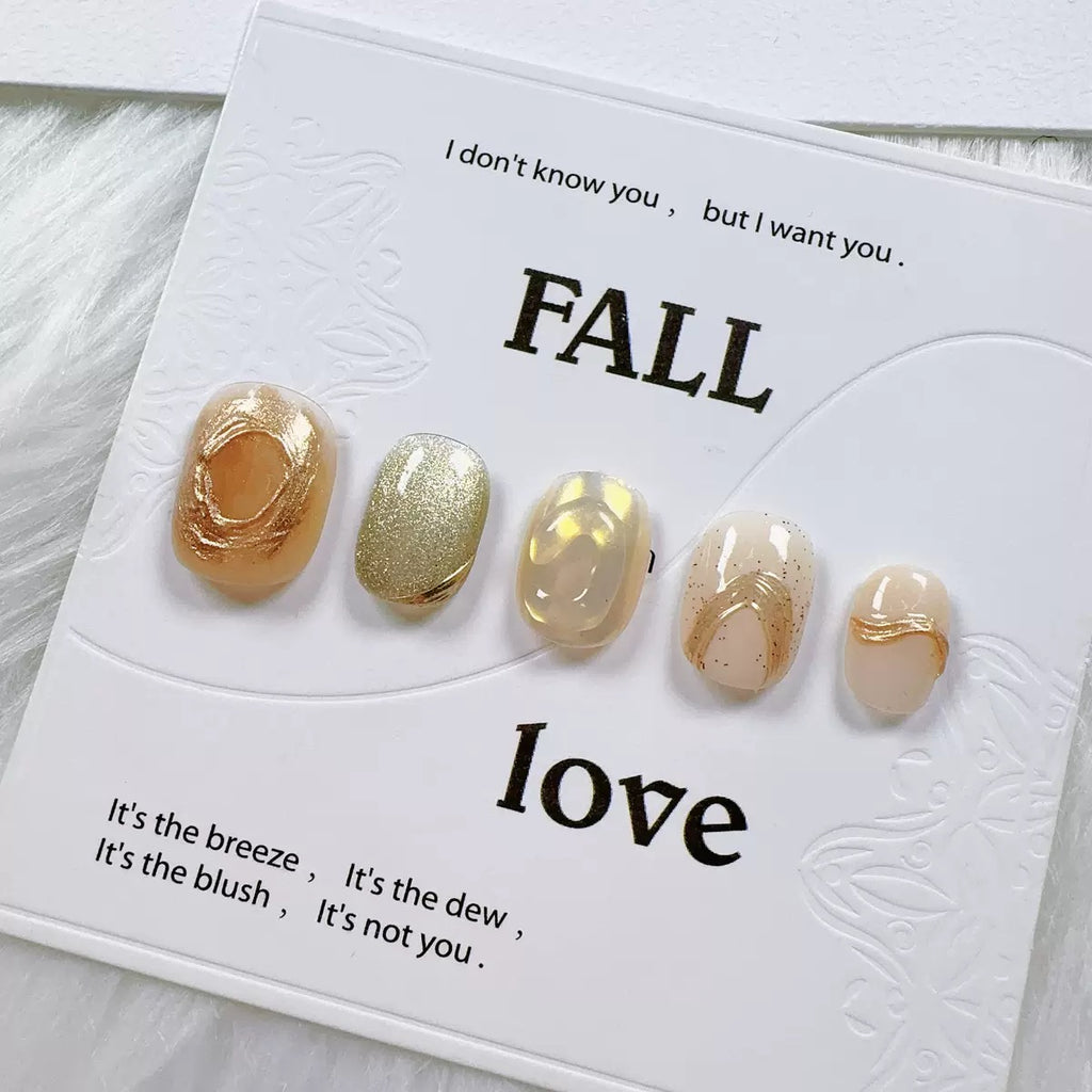Handmade nail art with gold cat's eye French manicure, gold foil and mother-of-pearl inlaid with engraved patterns.