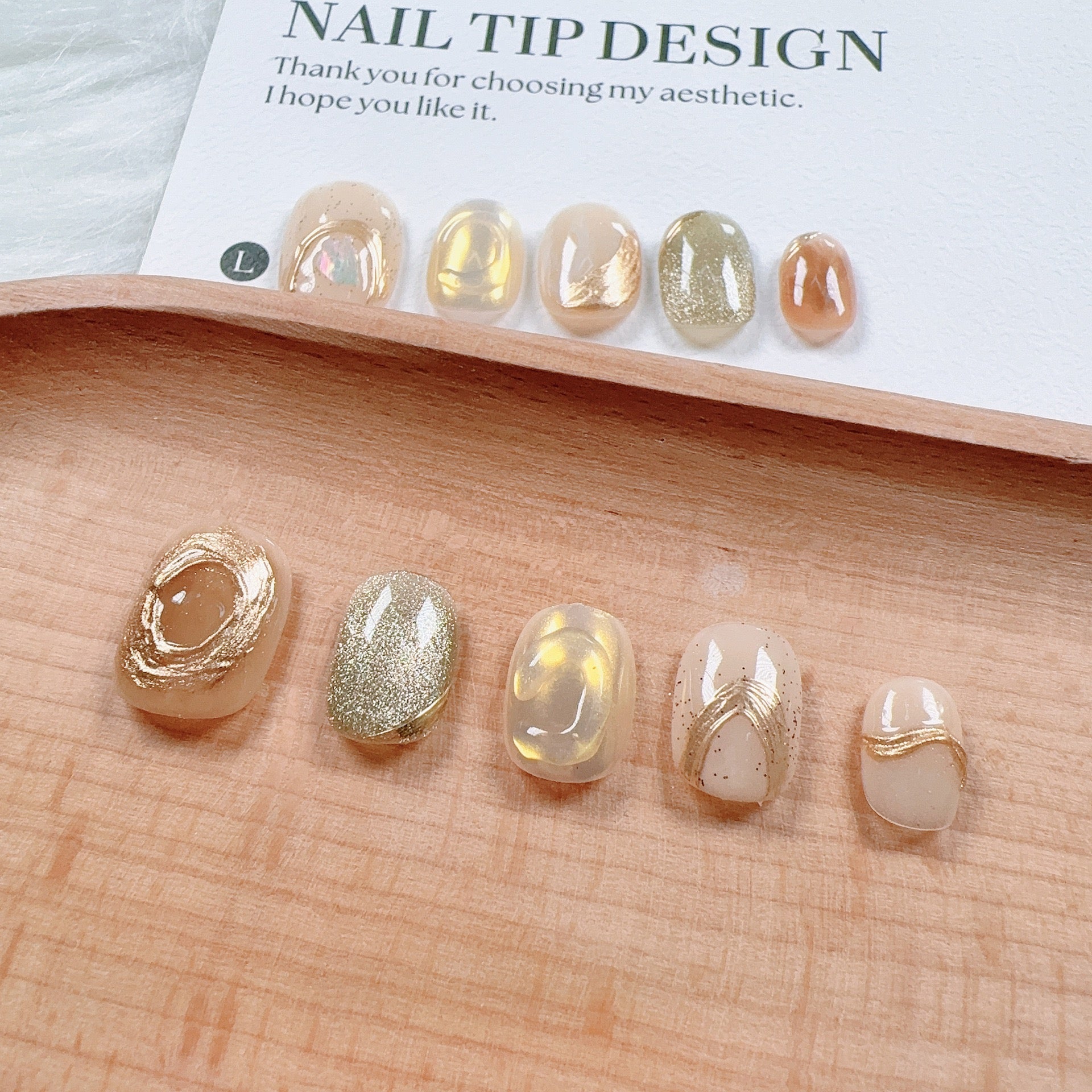Handmade nail art with gold cat's eye French manicure, gold foil and mother-of-pearl inlaid with engraved patterns.