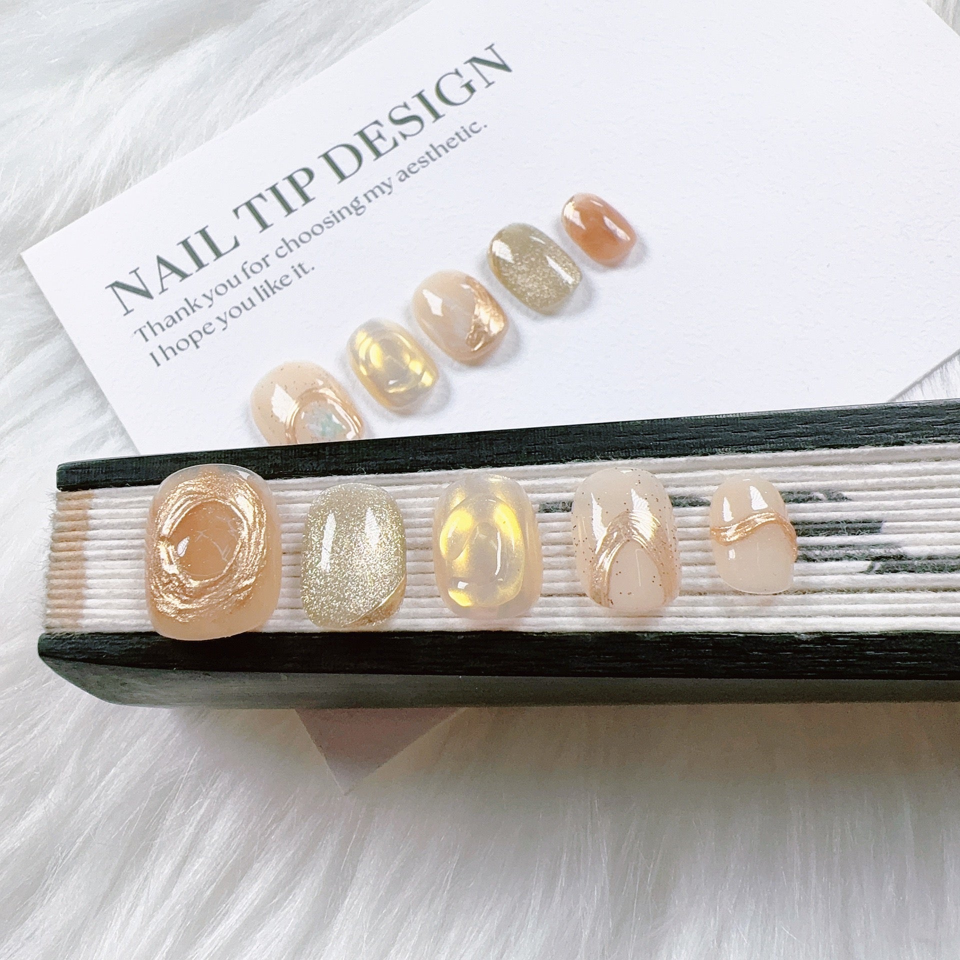Handmade nail art with gold cat's eye French manicure, gold foil and mother-of-pearl inlaid with engraved patterns.