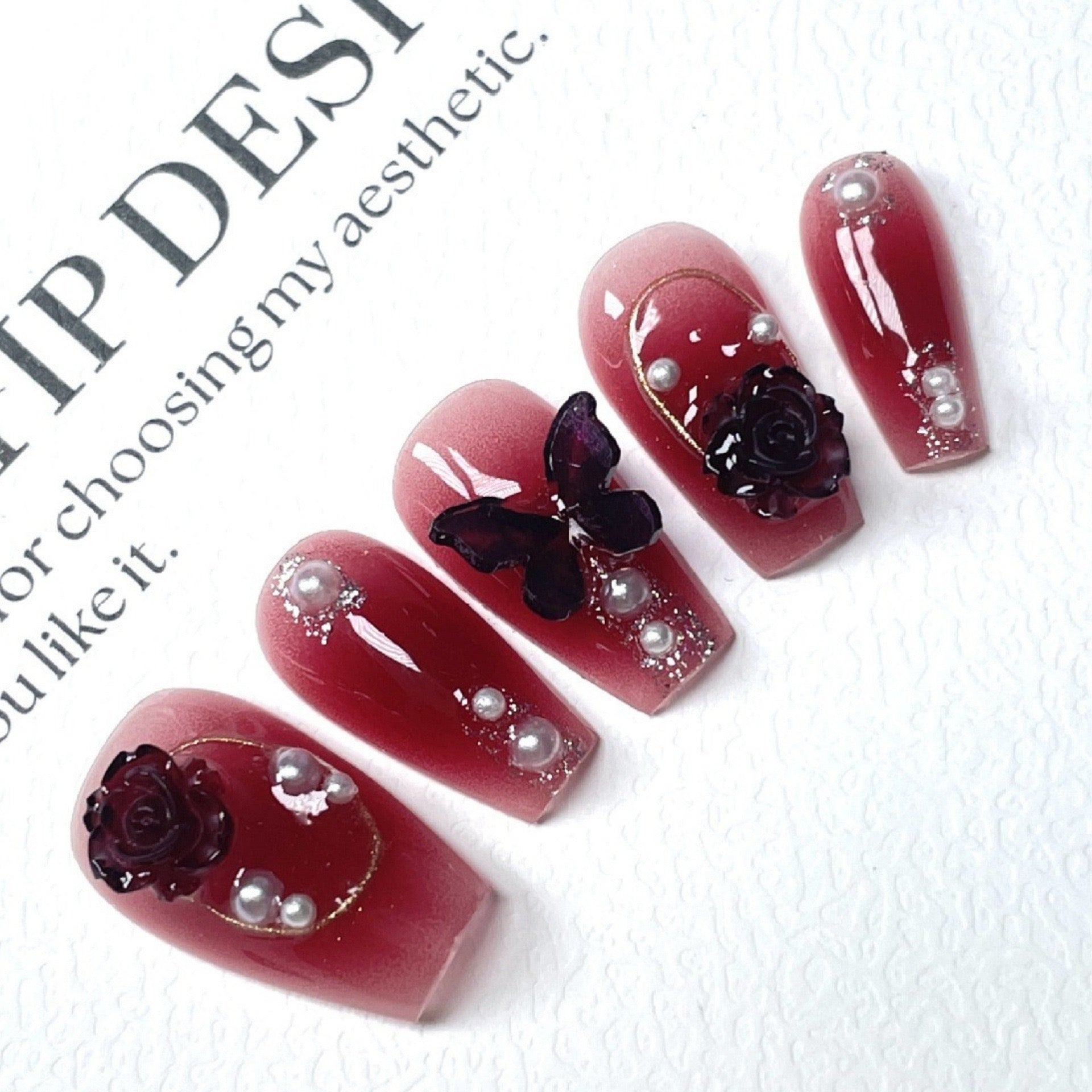 Dark red butterfly-shaped nail decorations for 2025 new style. Complementary accessories made of pure handcrafted materials. Environmentally friendly. Easy to wear. Suitable for parties and daily outings.